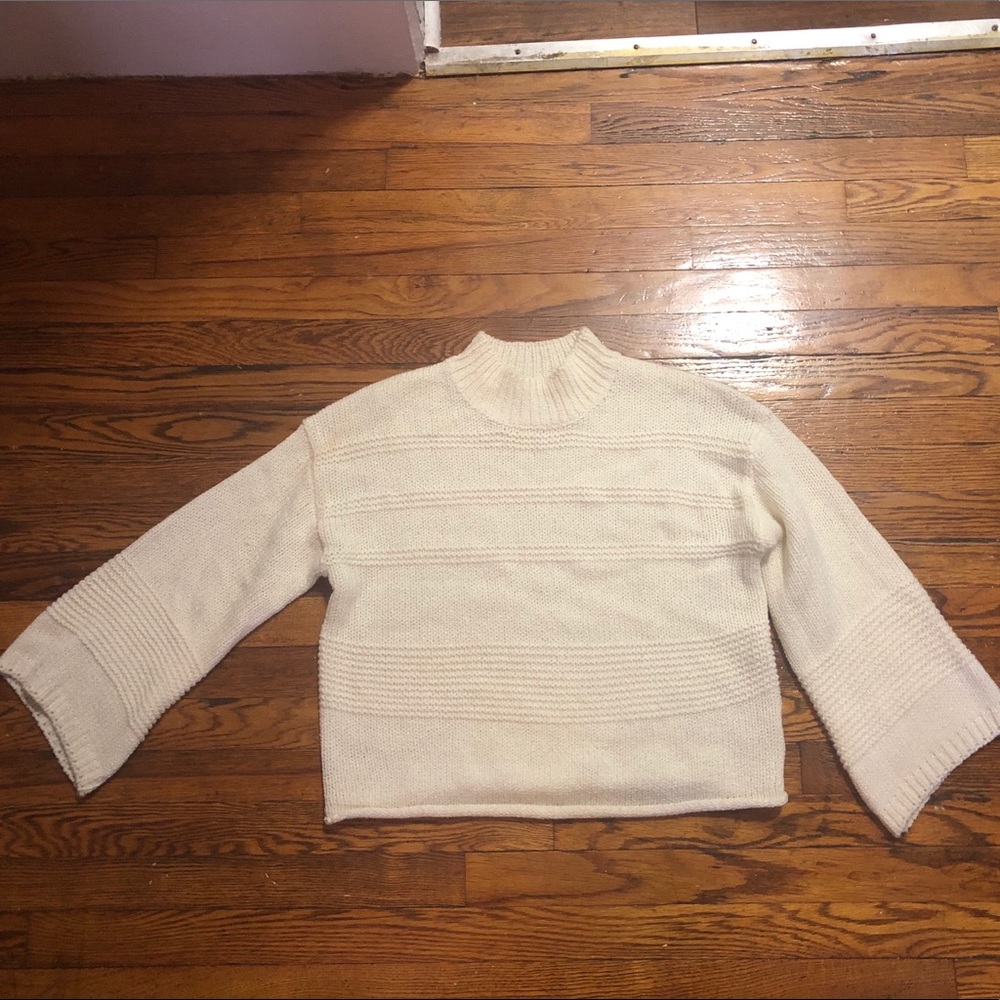 A cream colored sweater from Lush
